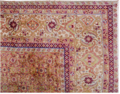 A vintage Persian Tabriz rug featuring an intricate floral medallion design in soft, muted tones.