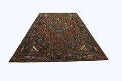 A vintage Persian Tabriz rug featuring intricate geometric patterns in red, blue, and brown tones.
