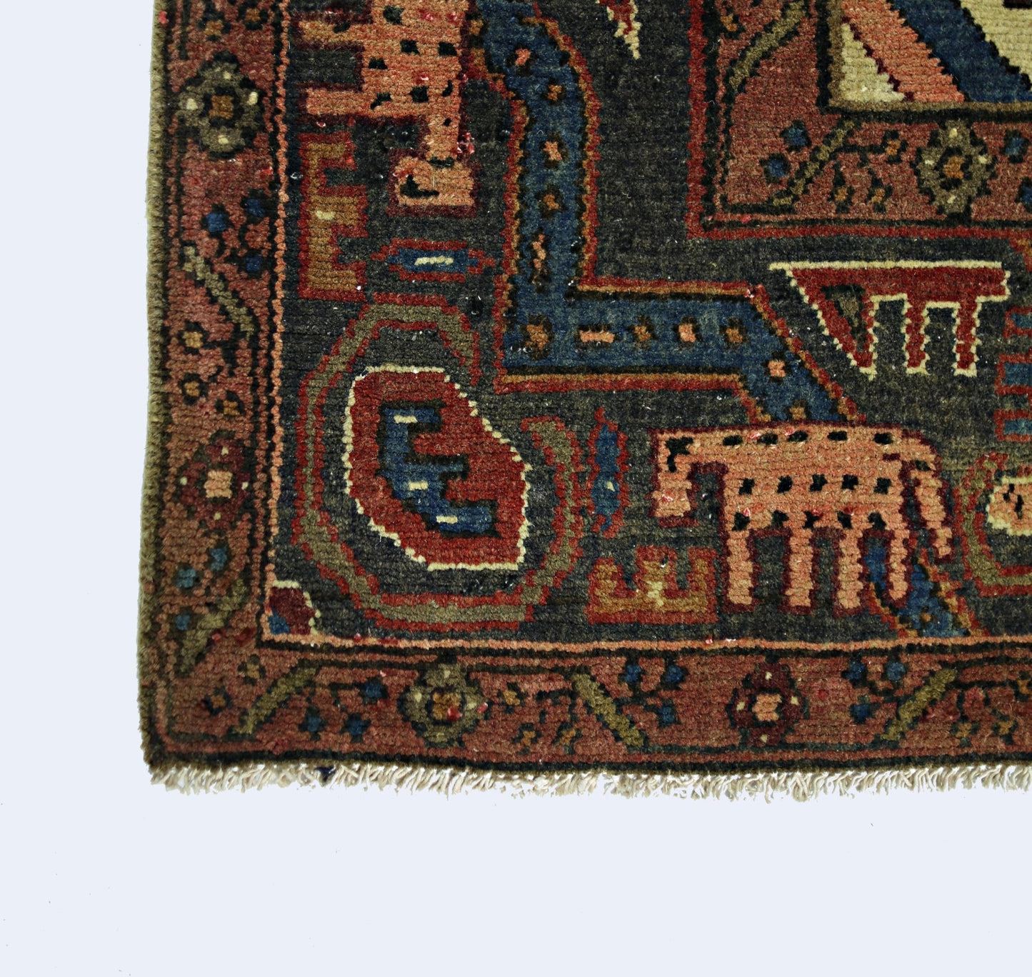 A corner view of a vintage Persian Tabriz rug featuring intricate geometric patterns in wool.