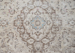 A vintage Persian Kerman rug featuring a central medallion with intricate floral patterns.