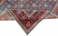 A vintage handwoven Persian Tabriz rug featuring intricate floral patterns in red and blue tones.