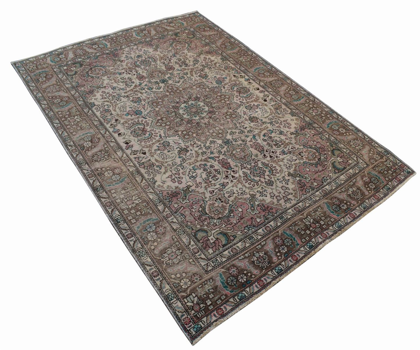 A vintage handwoven Persian Tabriz rug featuring intricate floral patterns in muted earth tones.