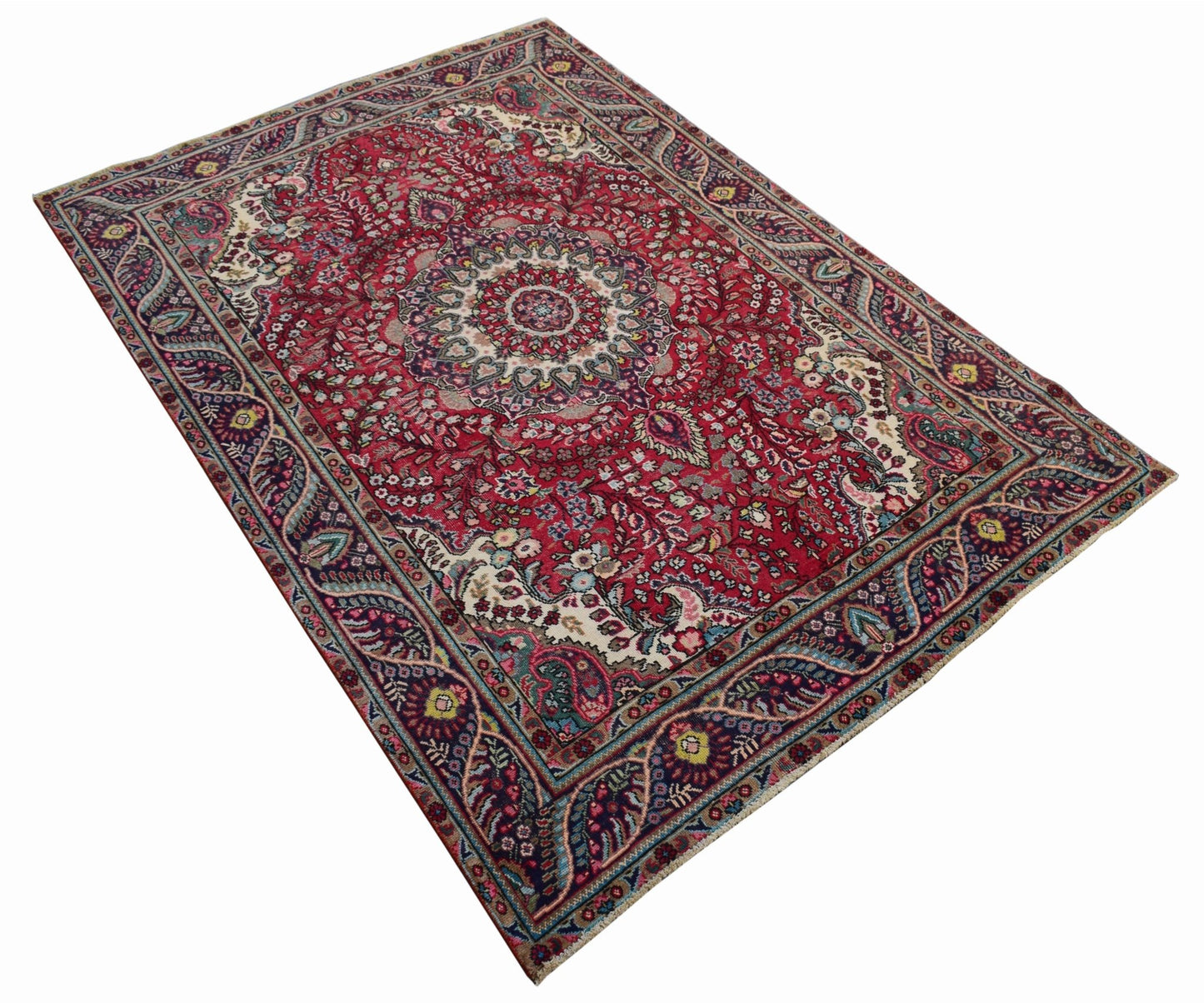 A vintage Persian Tabriz rug featuring a central medallion and intricate floral patterns in red.