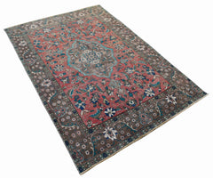 A vintage Persian Tabriz rug featuring a central medallion and intricate floral patterns.