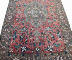 Vintage Persian Tabriz rug featuring a central medallion and intricate floral patterns in red.