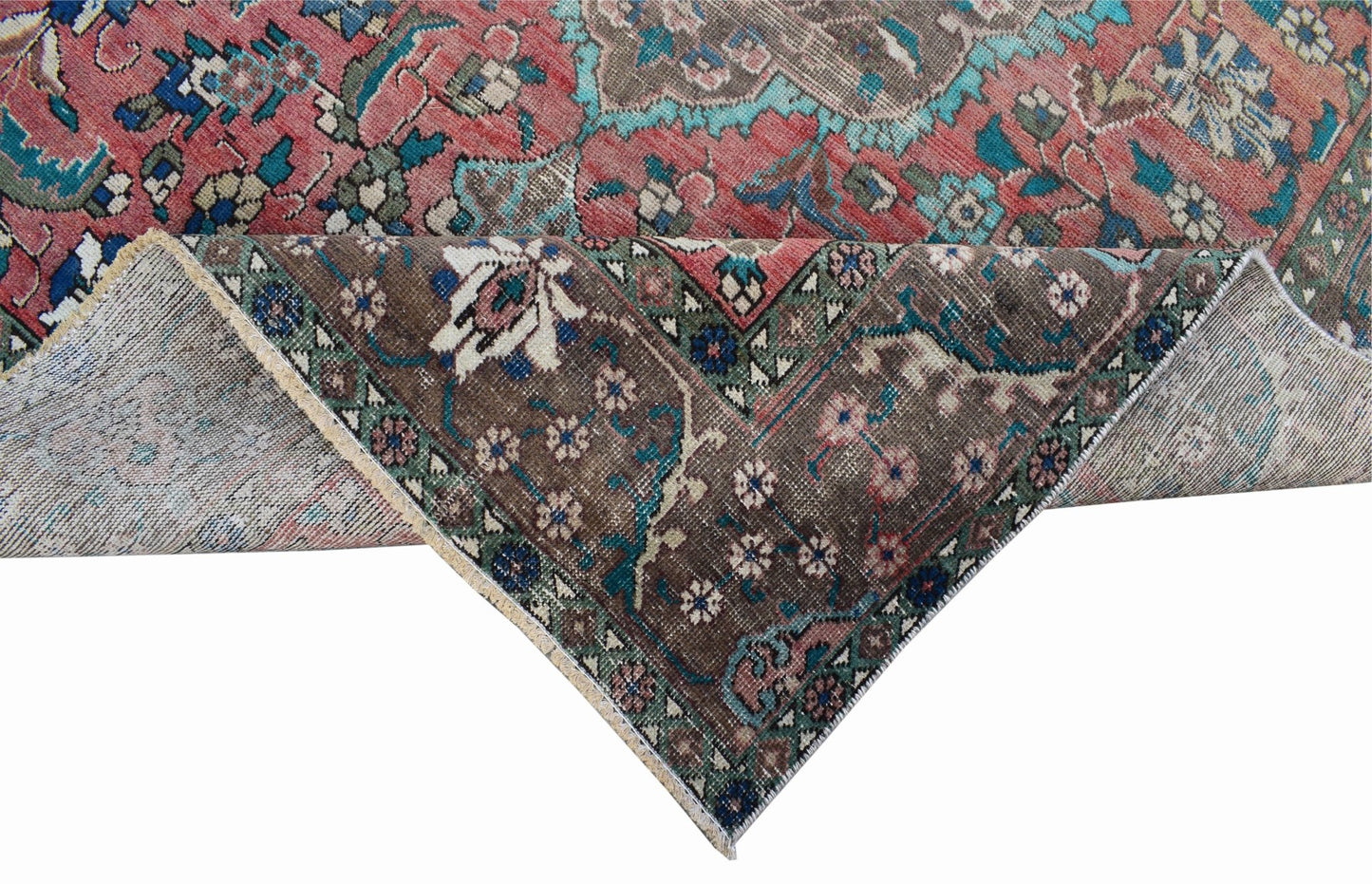 A vintage Persian Tabriz rug featuring a floral medallion design in red, brown, and teal tones.