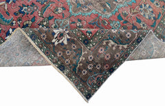 A vintage Persian Tabriz rug featuring a floral medallion design in red, brown, and teal tones.