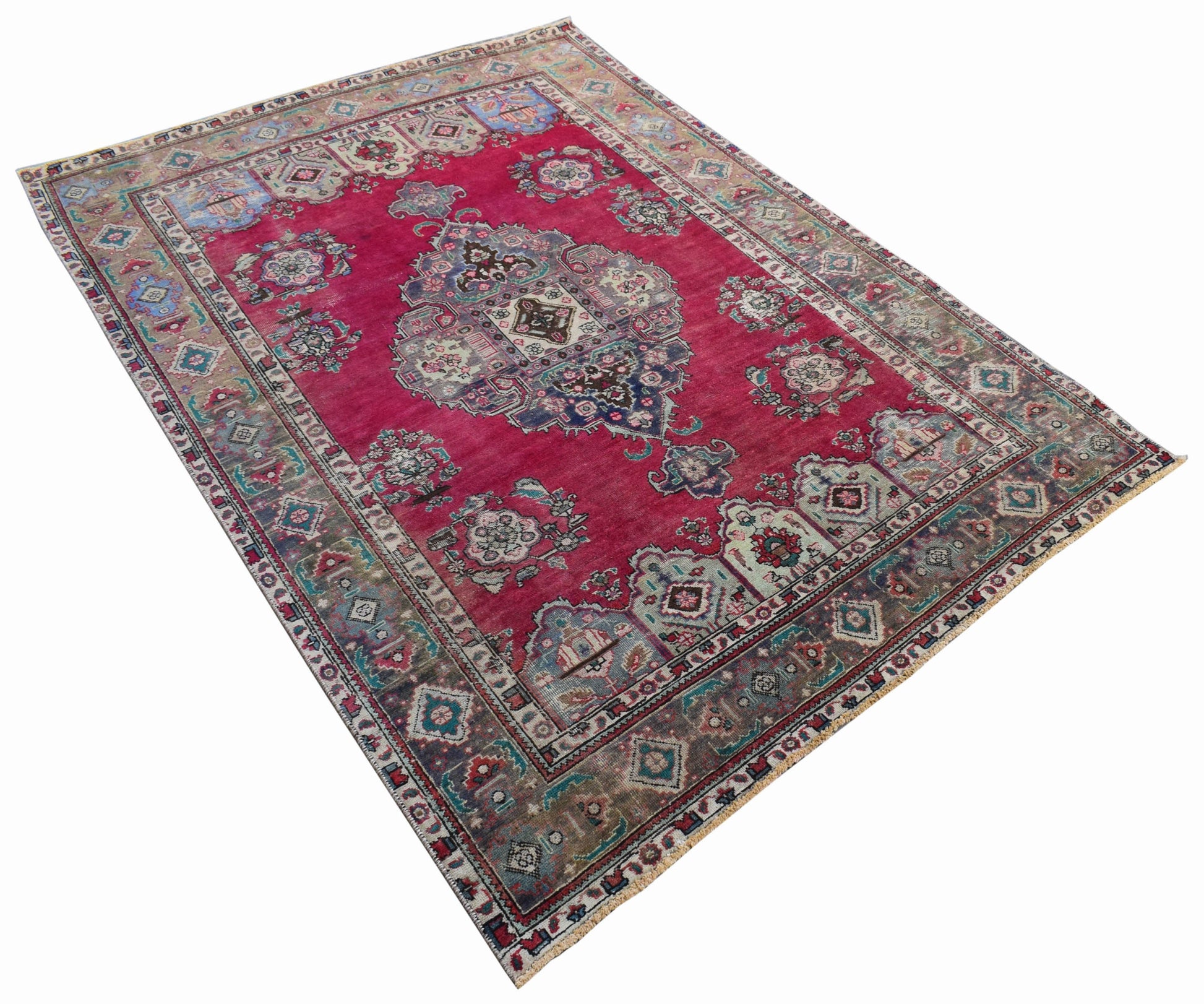 A vintage Persian Tabriz rug featuring a central medallion and intricate floral patterns in red.