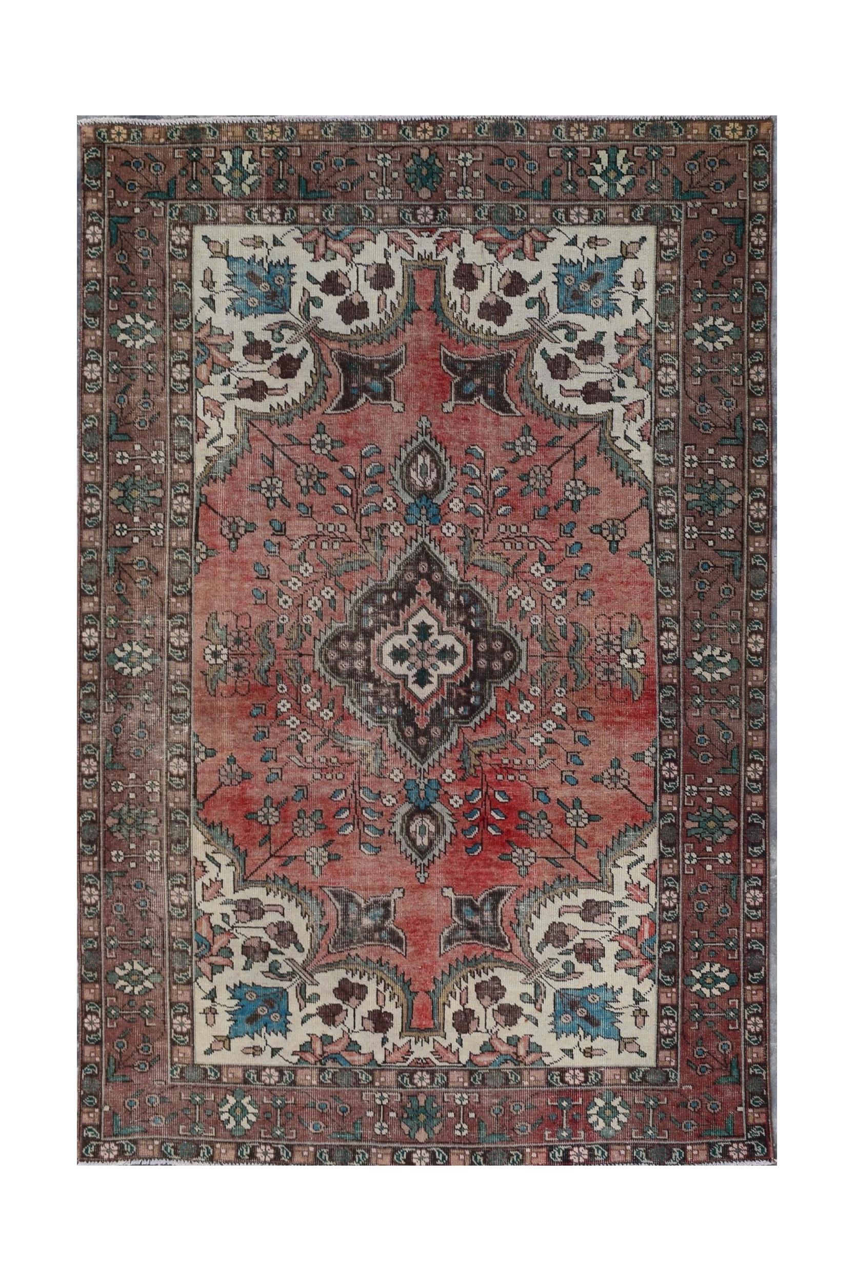 A vintage Persian Tabriz rug featuring a central medallion and intricate floral patterns in red.