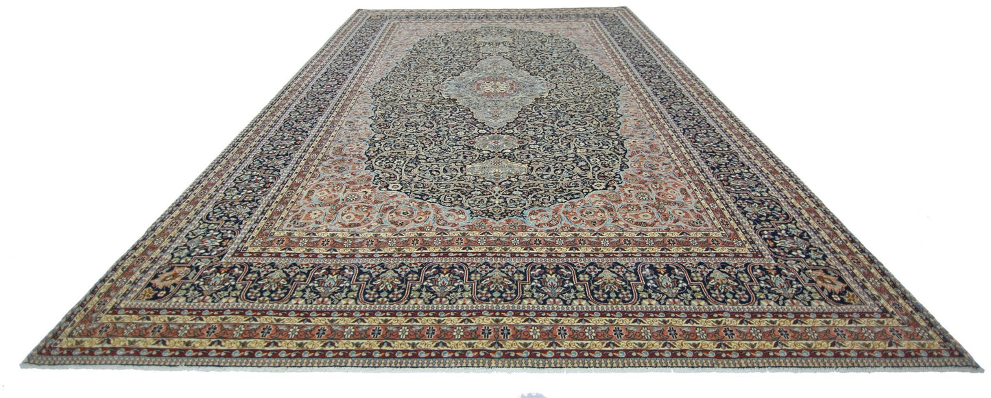 A vintage Persian Tabriz rug featuring an intricate floral pattern in navy, cream, and rust tones.