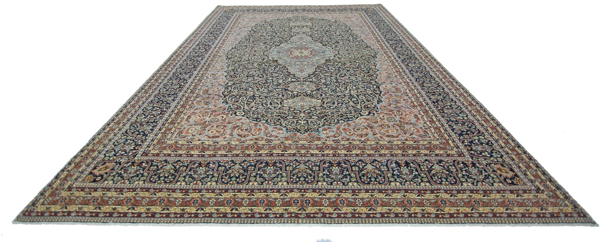 A vintage Persian Tabriz rug featuring an intricate floral pattern in navy, cream, and rust tones.