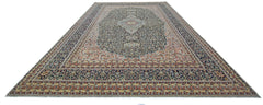 A vintage Persian Tabriz rug featuring an intricate floral pattern in navy, cream, and rust tones.