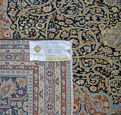 A vintage Persian Tabriz rug featuring intricate floral patterns in blue, cream, and rust tones.