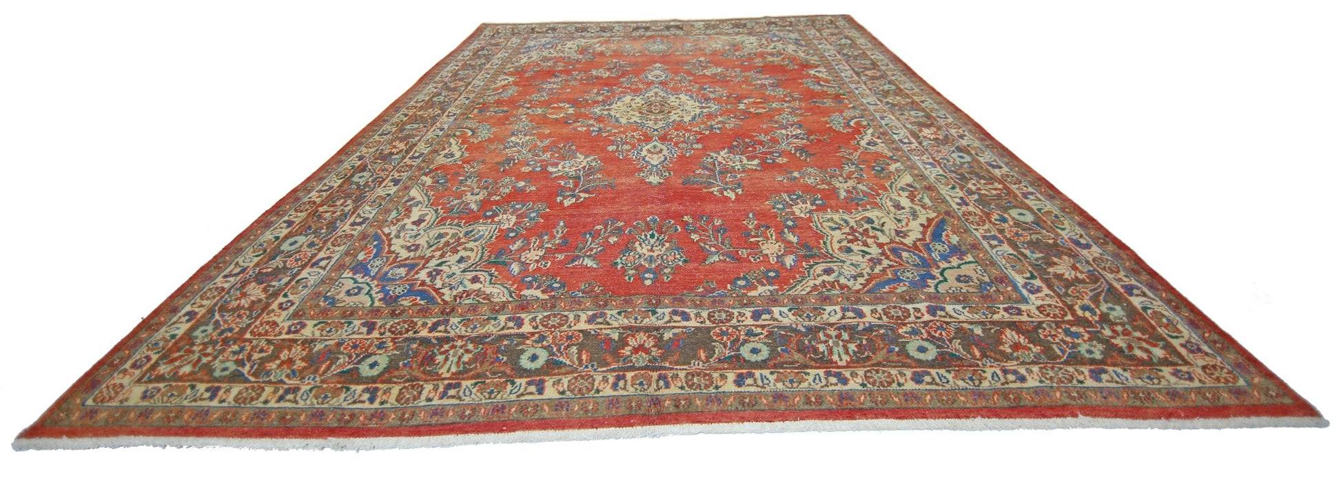 A vintage Persian Tabriz rug featuring a central medallion and floral patterns on a red field.