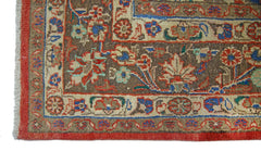 A corner view of a vintage Persian Tabriz rug featuring intricate floral patterns in earthy tones.