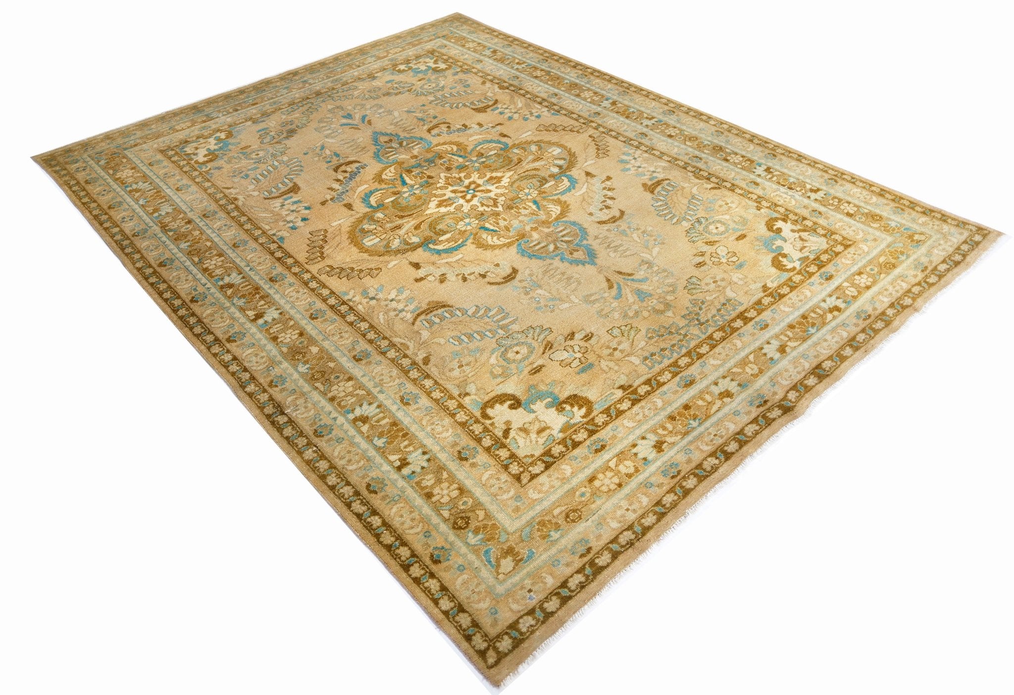 A vintage Persian Tabriz rug featuring an intricate floral medallion in beige and blue tones.