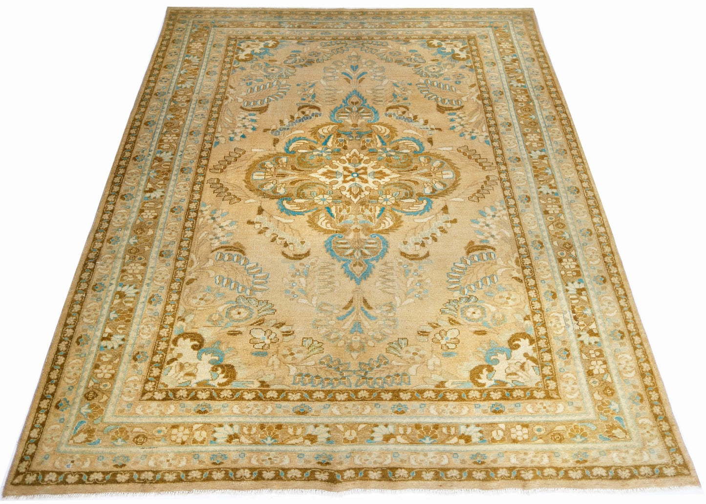 A vintage Persian Tabriz rug featuring a central floral medallion in blue and beige tones.