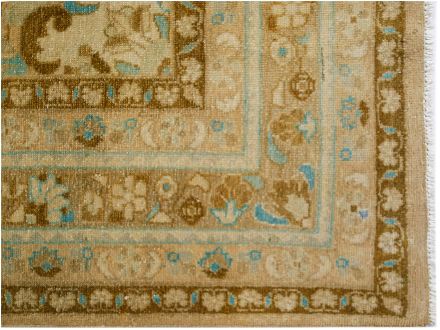 A vintage Persian Tabriz rug featuring intricate floral patterns in shades of brown and blue.