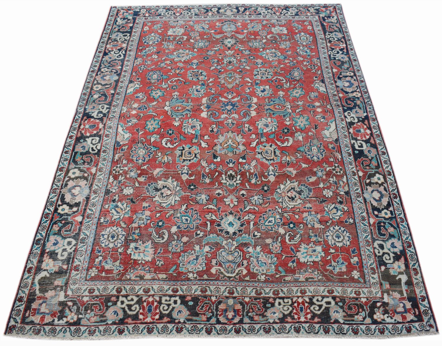 A vintage handwoven Persian Tabriz rug featuring intricate floral patterns in red and blue tones.