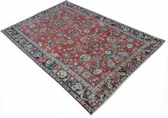 A vintage handwoven Persian Tabriz rug featuring intricate floral patterns in red and blue tones.