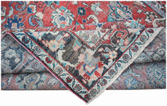 A vintage handwoven Persian Tabriz rug featuring intricate floral patterns in red and blue tones.