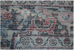A close-up view of a vintage Persian Tabriz rug featuring intricate floral patterns and wool pile.