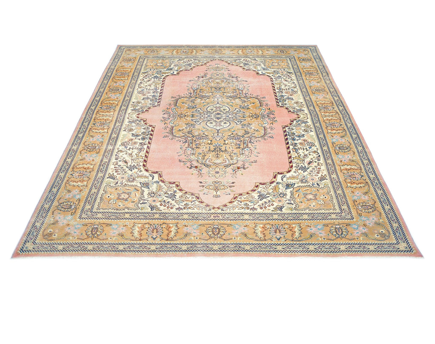 A vintage Persian Tabriz rug featuring an intricate floral medallion on a soft pink field.