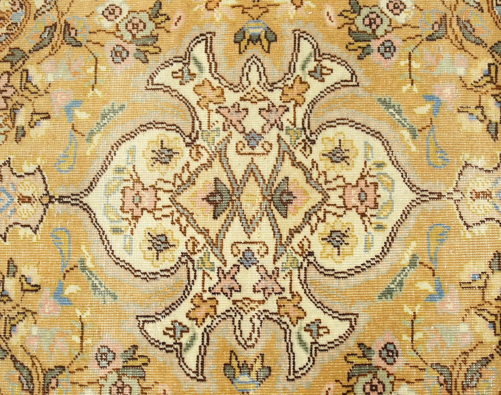 A vintage Persian Tabriz rug featuring an intricate floral medallion pattern in soft gold and cream.