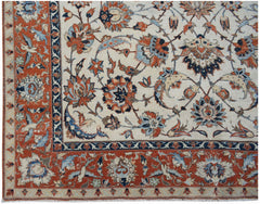 A vintage Persian Kashan rug featuring intricate floral patterns in red, blue, and cream tones.