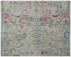 A vintage handwoven Persian Tabriz rug featuring a faded floral pattern in blue, pink, and beige.