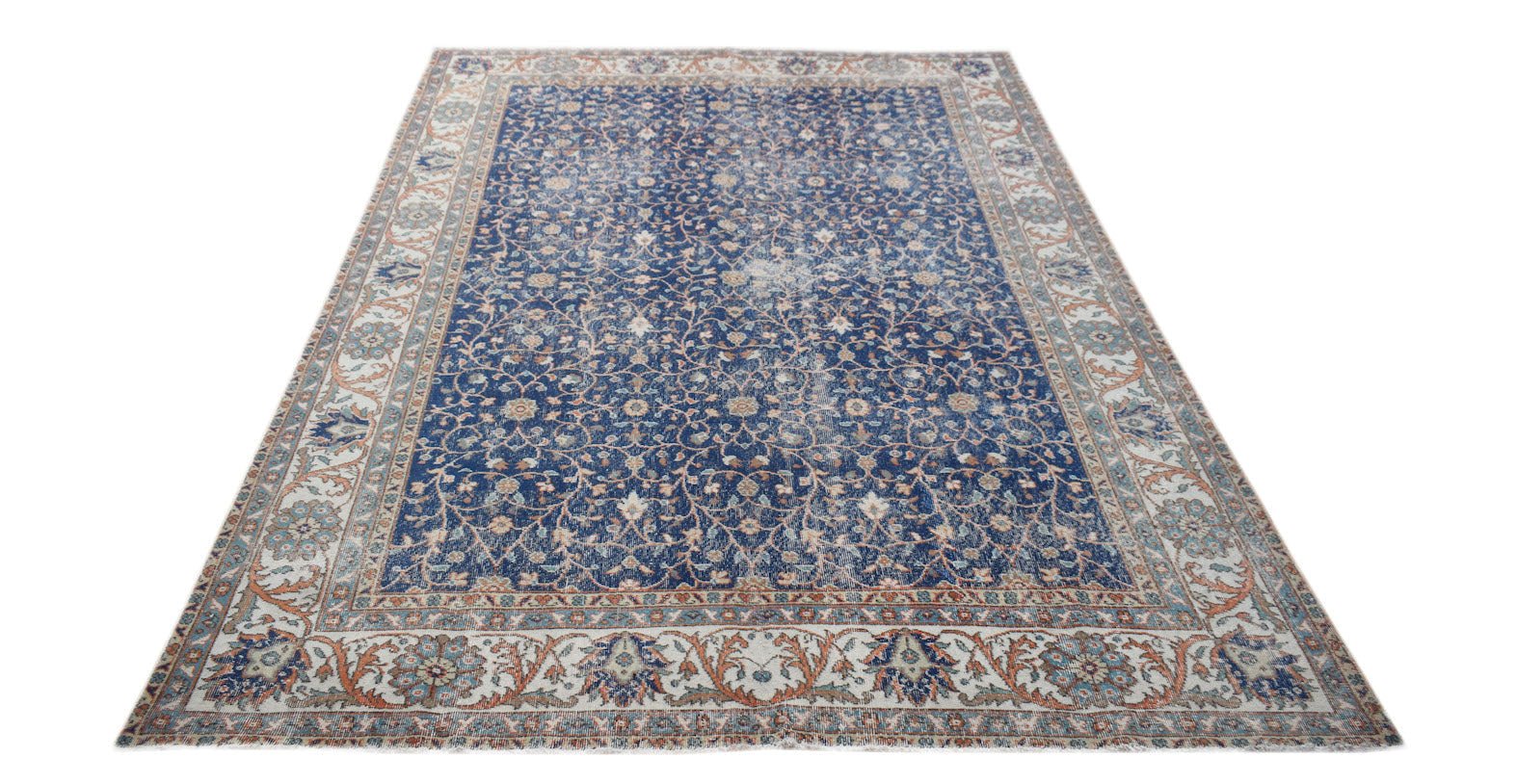 A vintage Persian Tabriz rug featuring a blue field with intricate floral patterns and a wide border.