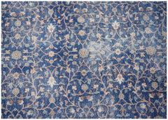 A vintage Persian Tabriz rug featuring an intricate floral pattern in shades of blue and cream.