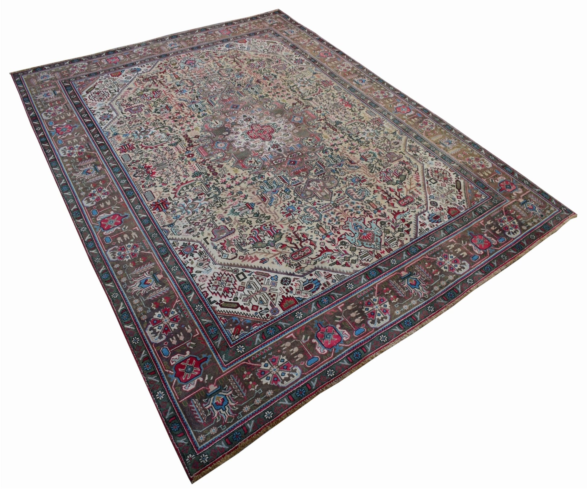 A vintage handwoven Persian Tabriz rug featuring intricate floral patterns in a muted color palette.