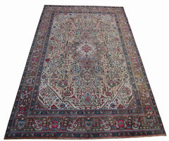 A vintage handwoven Persian Tabriz rug featuring intricate floral patterns in a neutral palette.