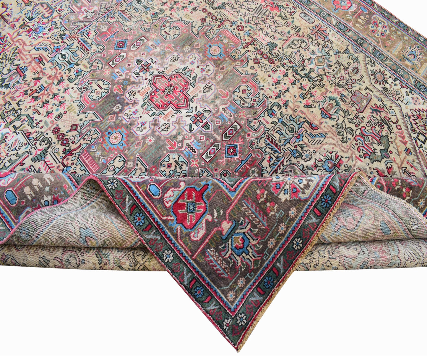 A vintage handwoven Persian Tabriz rug featuring intricate floral patterns in a muted color palette.