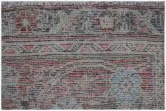 A close-up view of a vintage handwoven Persian Tabriz rug featuring intricate floral patterns.