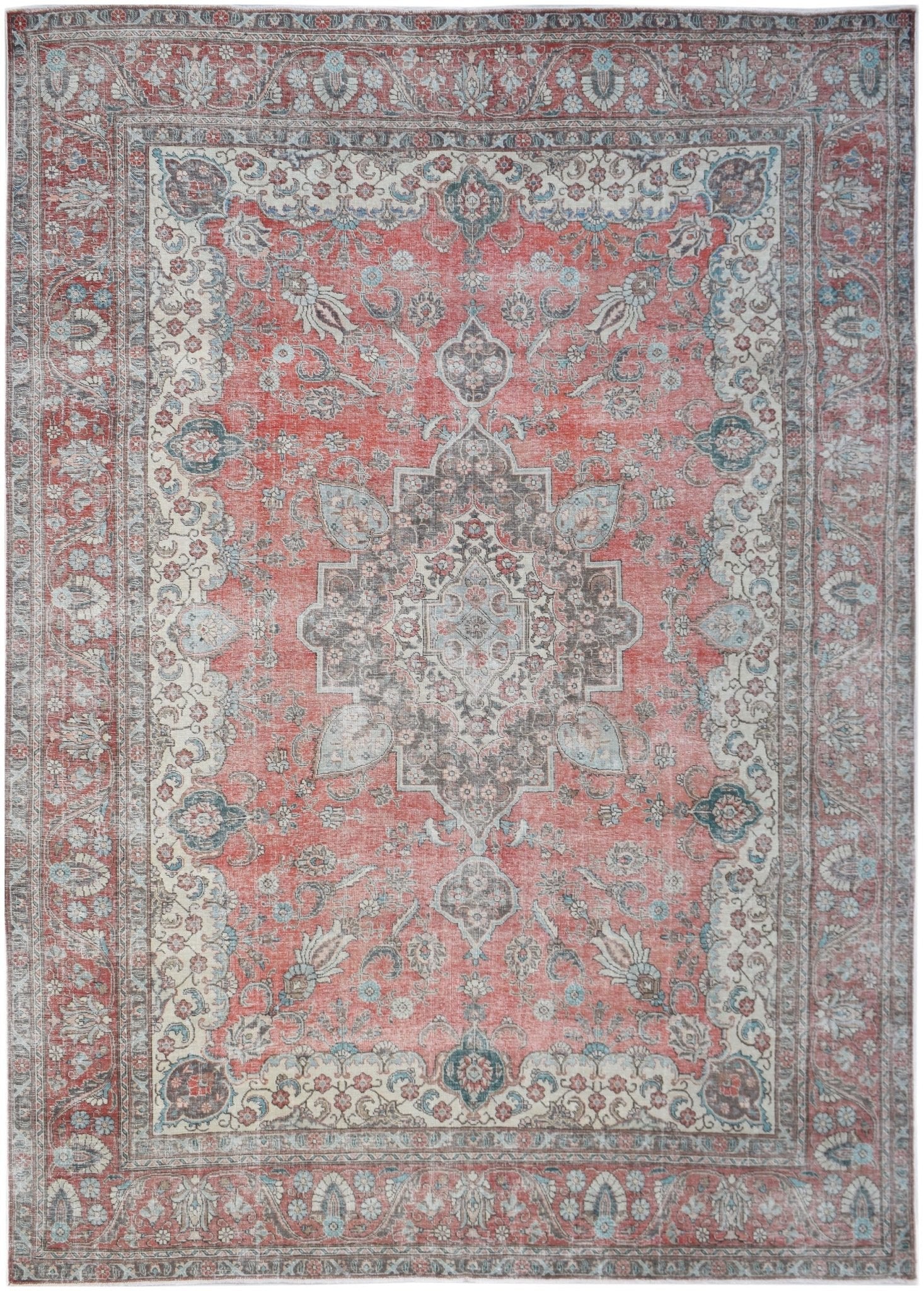 A vintage Persian Tabriz rug featuring a central medallion and floral patterns in red and grey.