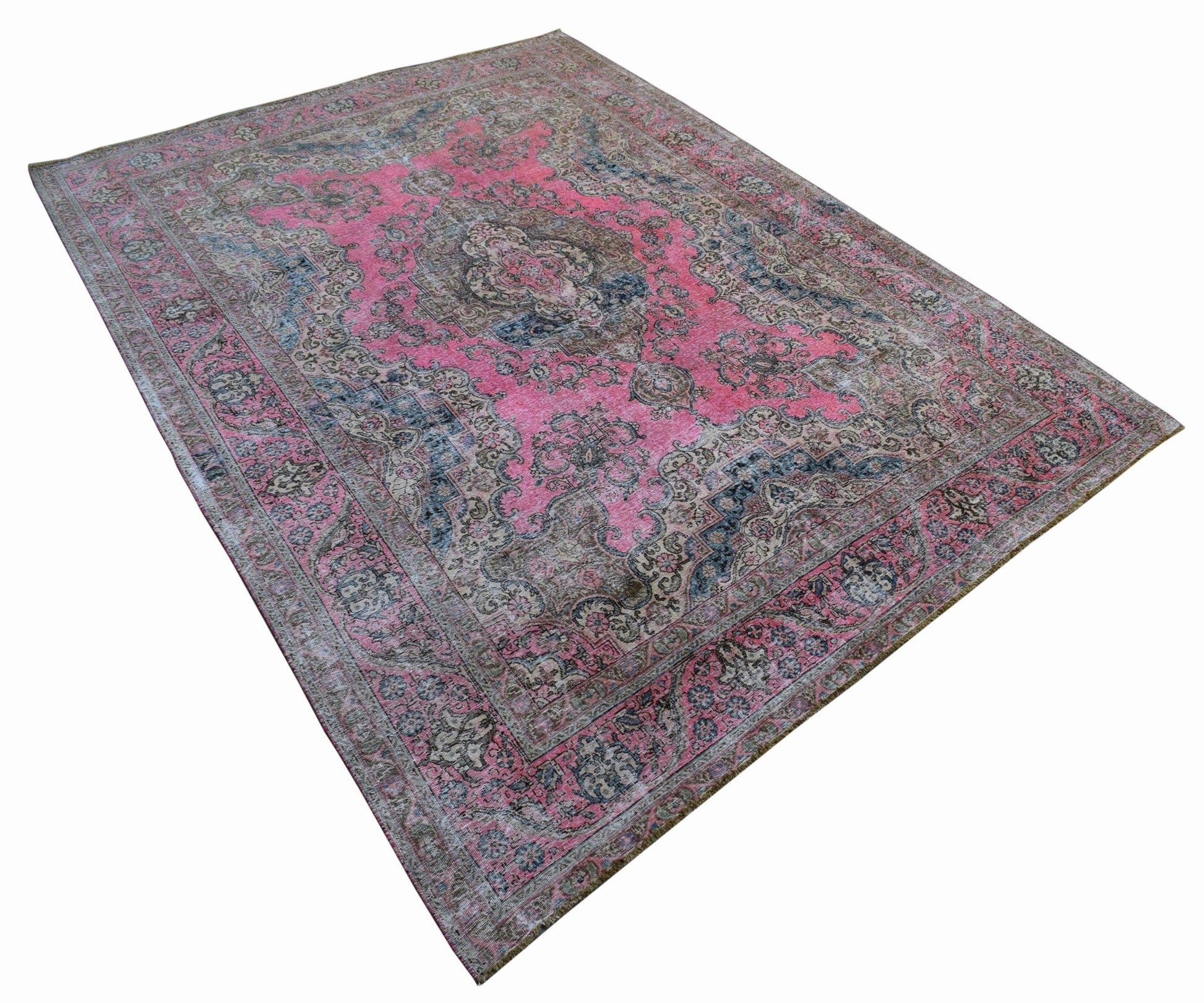 A vintage handwoven Persian Tabriz rug featuring intricate floral patterns in pink and blue tones.