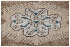 Vintage Persian Tabriz runner with a central medallion and intricate patterns in beige and brown.