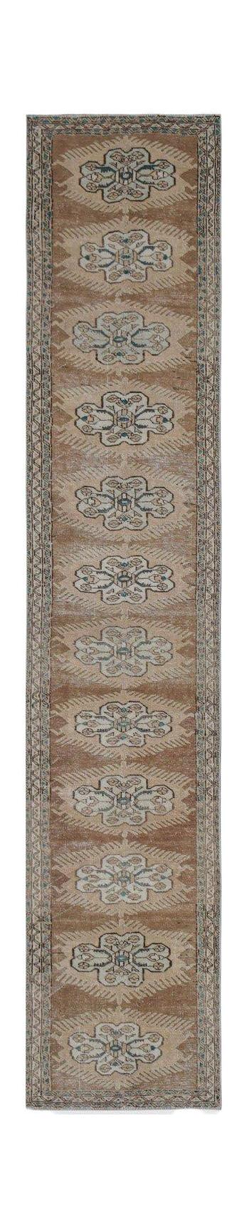 Vintage Persian Tabriz runner with a repeating floral pattern in brown and blue.