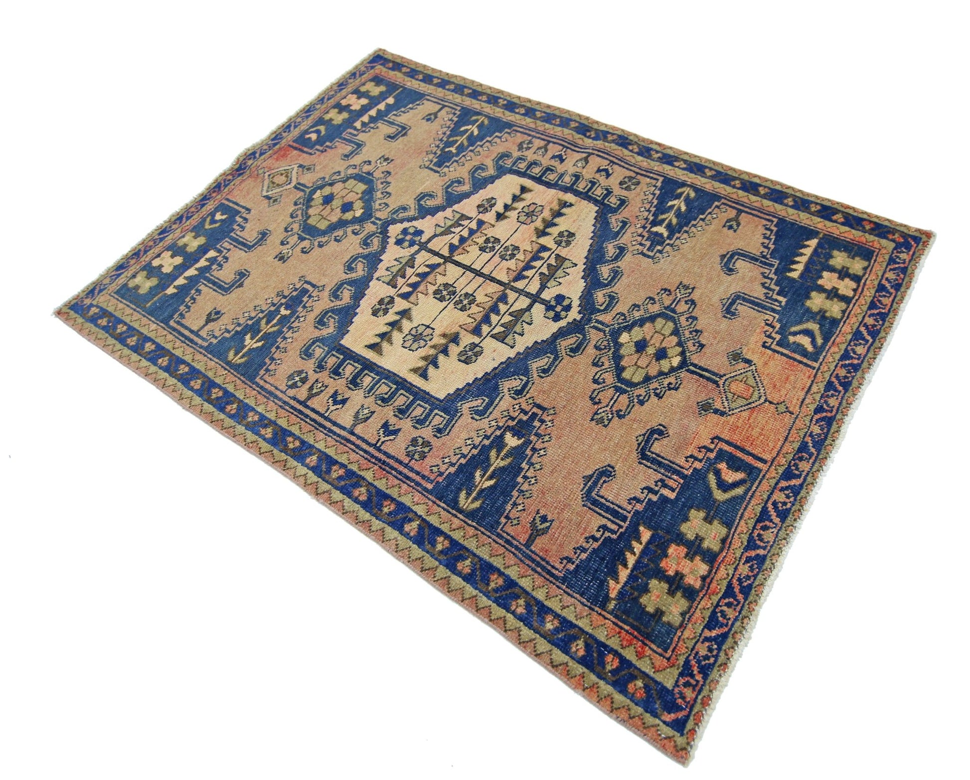 A vintage Persian Wiss rug featuring a geometric floral pattern in blue, beige, and orange tones.