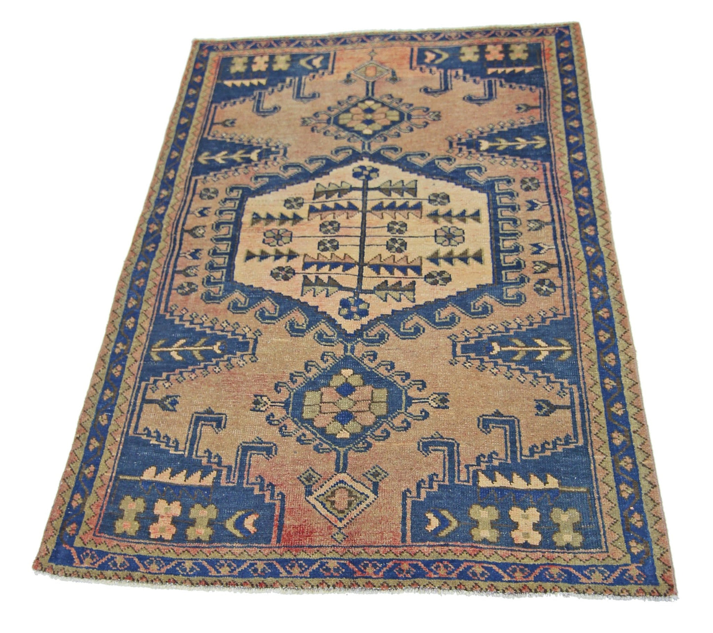 A vintage Persian Wiss rug featuring a geometric blue and tan pattern on a wool pile.