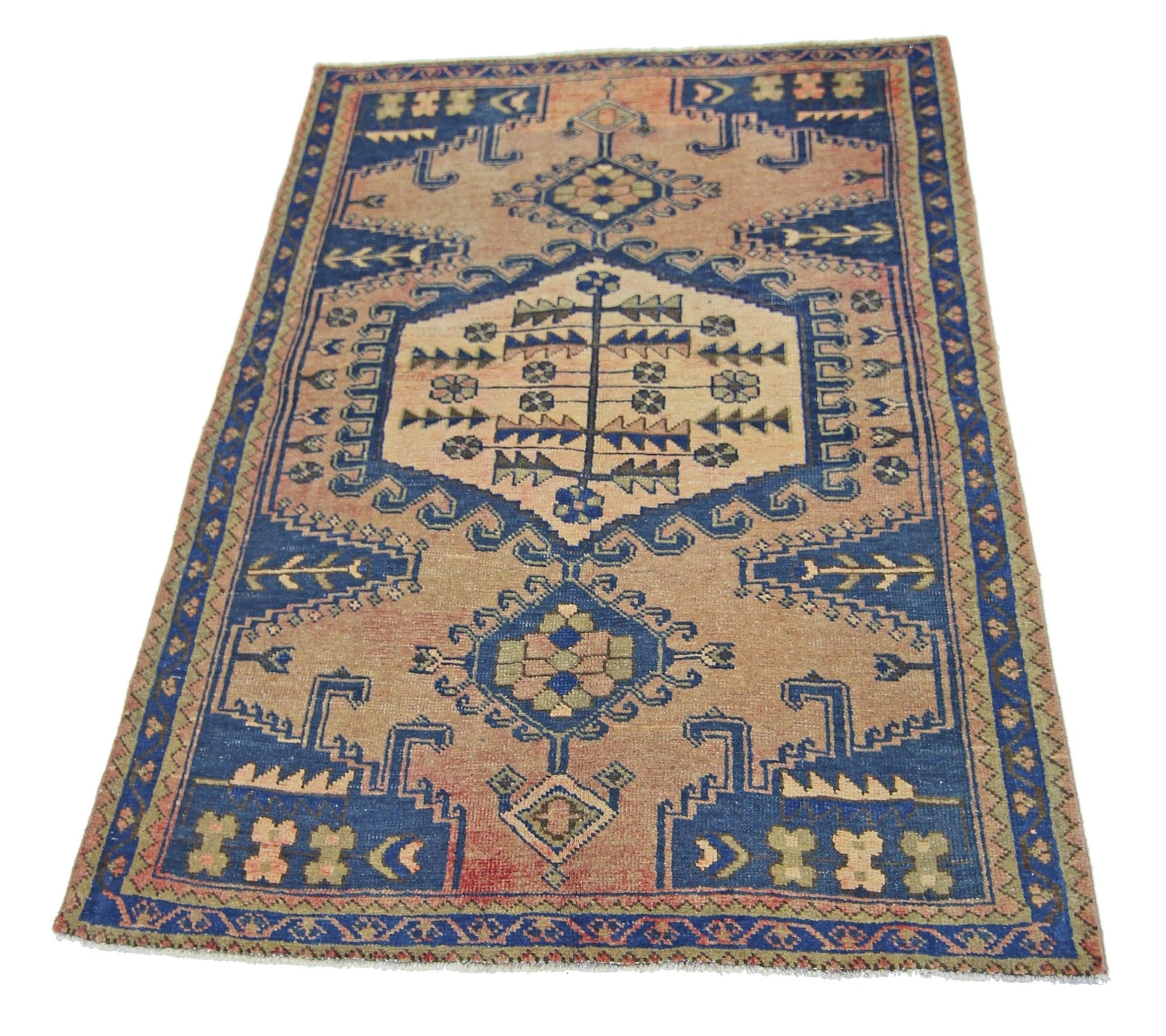 A vintage Persian Wiss rug featuring a geometric blue and tan pattern on a wool pile.