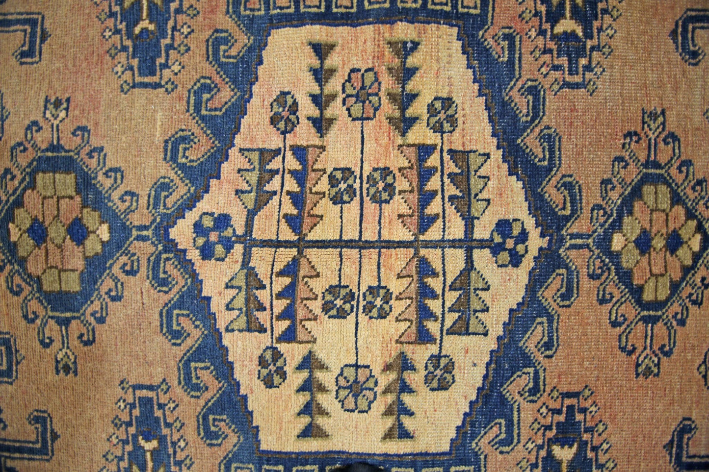 A vintage Persian Wiss rug featuring a central geometric medallion with floral and tree motifs.