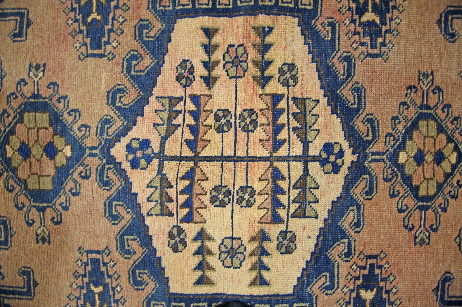 A vintage Persian Wiss rug featuring a central geometric medallion with floral and tree motifs.