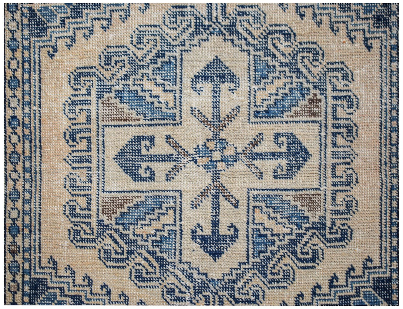 A vintage Persian Wiss rug featuring a blue and beige geometric medallion pattern.