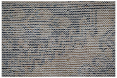 A close-up view of a handwoven vintage Persian rug featuring a textured, distressed wool pattern.