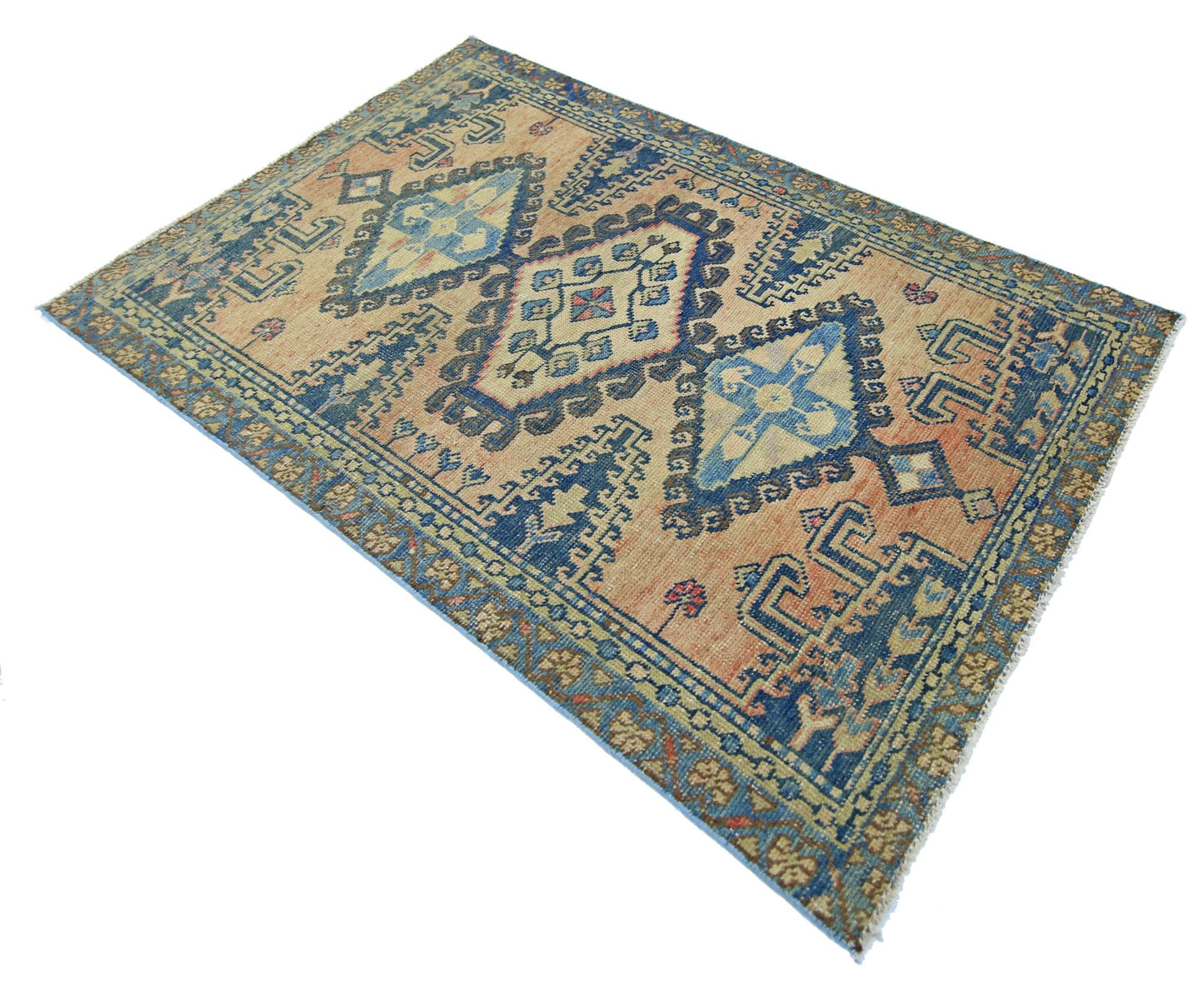 A vintage Persian Wiss rug featuring a geometric diamond pattern in blue and tan wool.