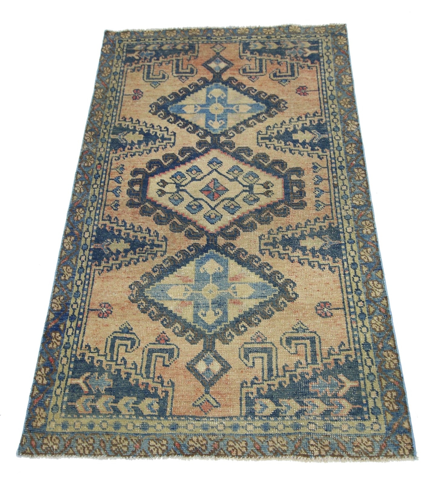 A vintage Persian Wiss rug featuring a geometric diamond pattern in blue and tan tones.