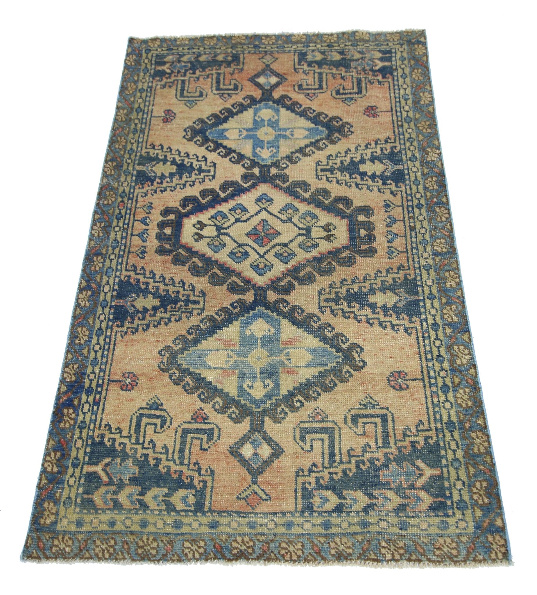 A vintage Persian Wiss rug featuring a geometric diamond pattern in blue and tan tones.